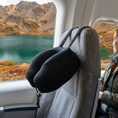 Cabeau Evolution S3 travel pillow secured to an airplane seat