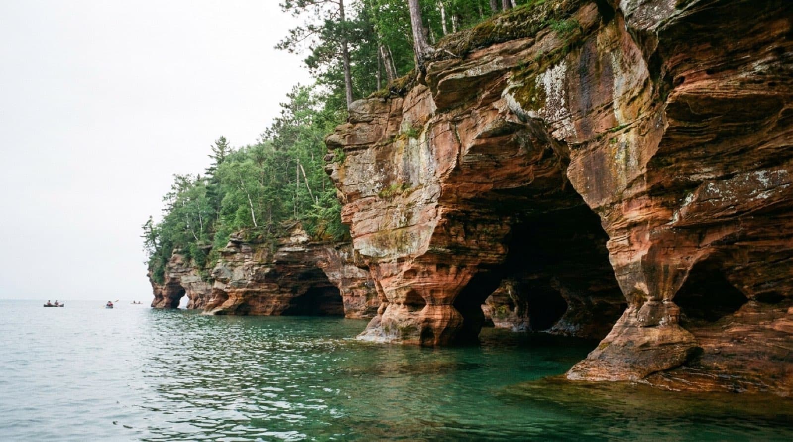 Sandstone mainland sea caves of the Apostle Islands above clear Lake Superior water