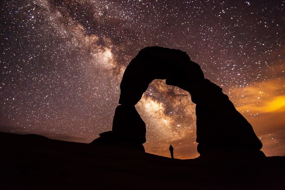A star-filled sky over Delicate Arch in Arches National Park