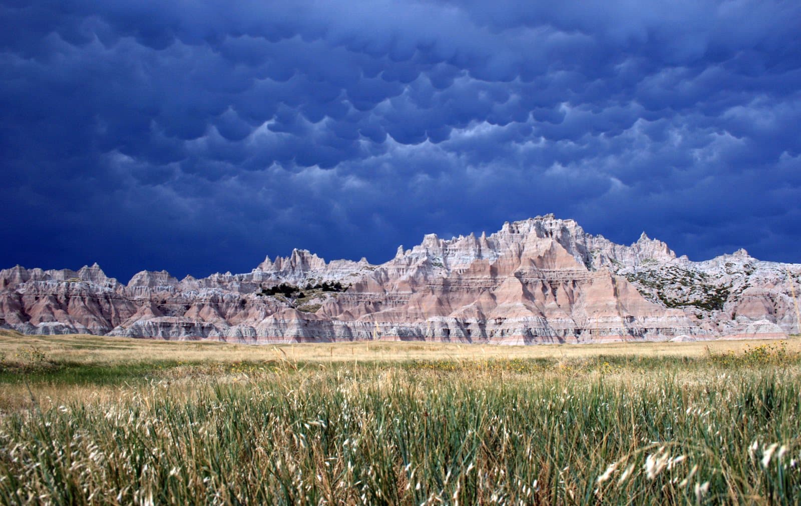Layered Badlands formations below a building storm