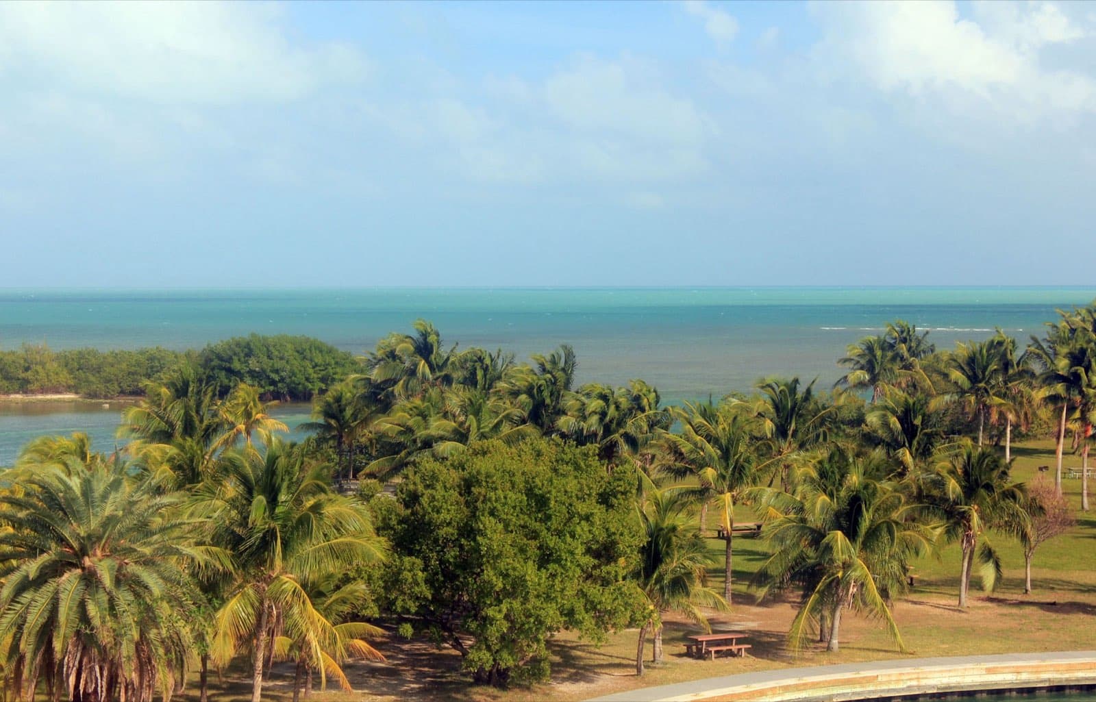 Calm turquoise waters of Biscayne Bay at Biscayne National Park, Florida, looking out past Boca Chita Key toward the open ocean under a bright sky