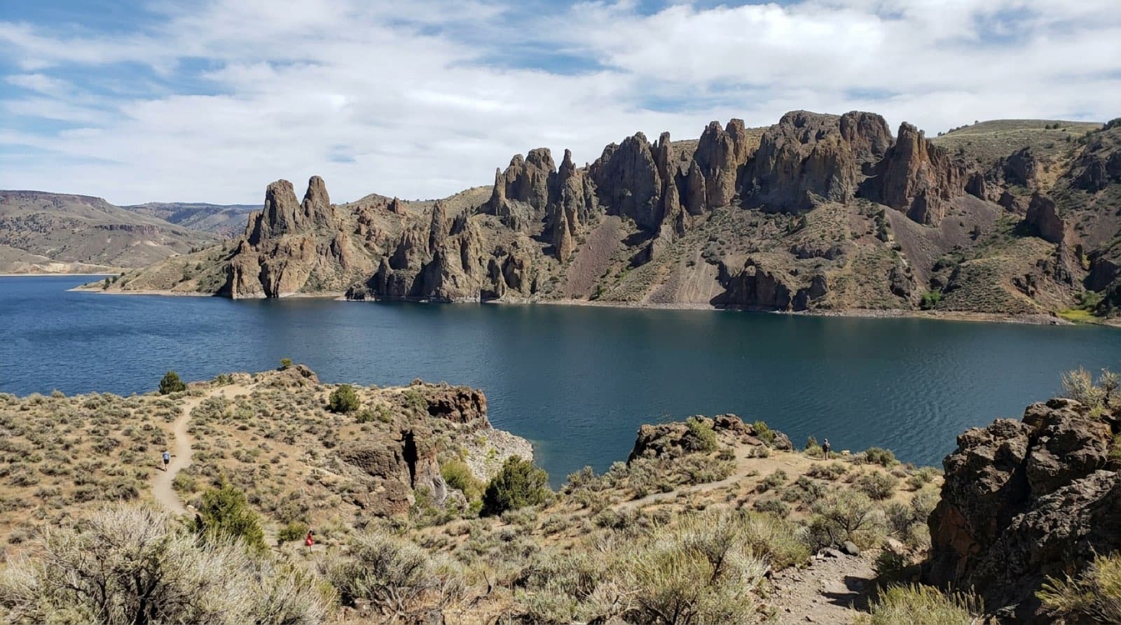 Blue Mesa Reservoir blue water below the eroded Dillon Pinnacles spires