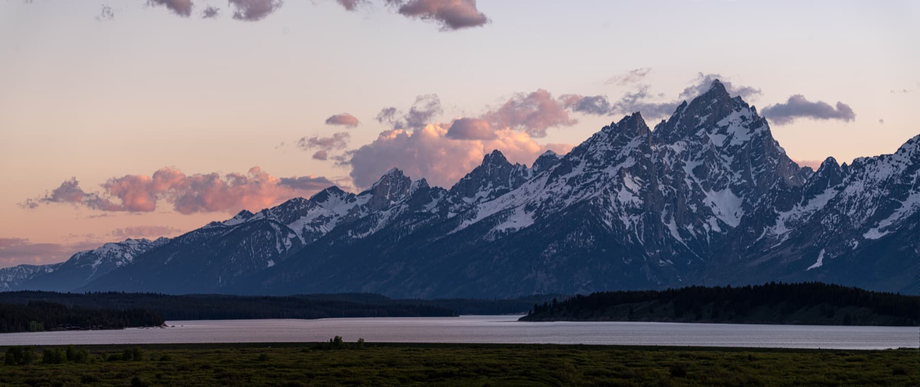 A wide view of the Teton Range rising from Jackson Hole