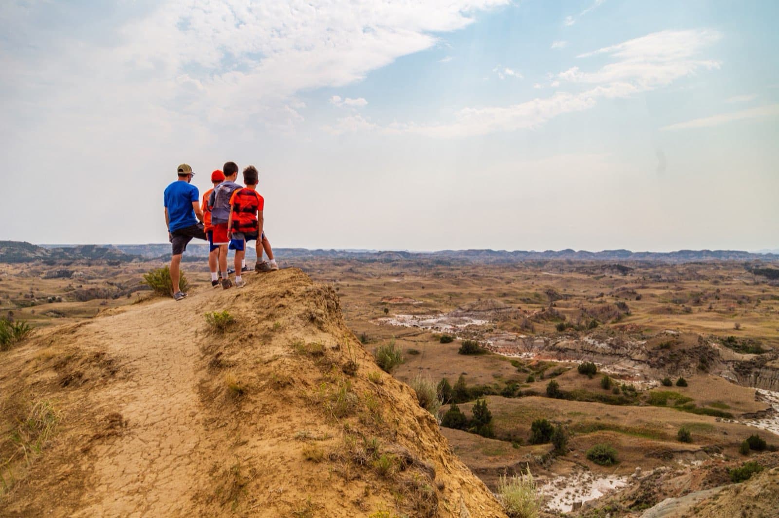 A sweeping view from the Boicourt Overlook in Theodore Roosevelt National Park, North Dakota, looking out over layered, eroded buttes and rolling badlands prairie under a wide sky.