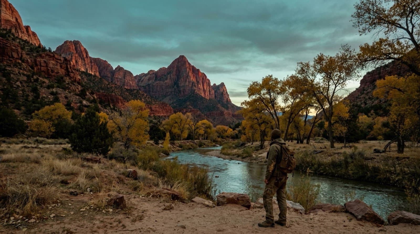 Zion Canyon at dusk, the sandstone walls glowing red above the Virgin River