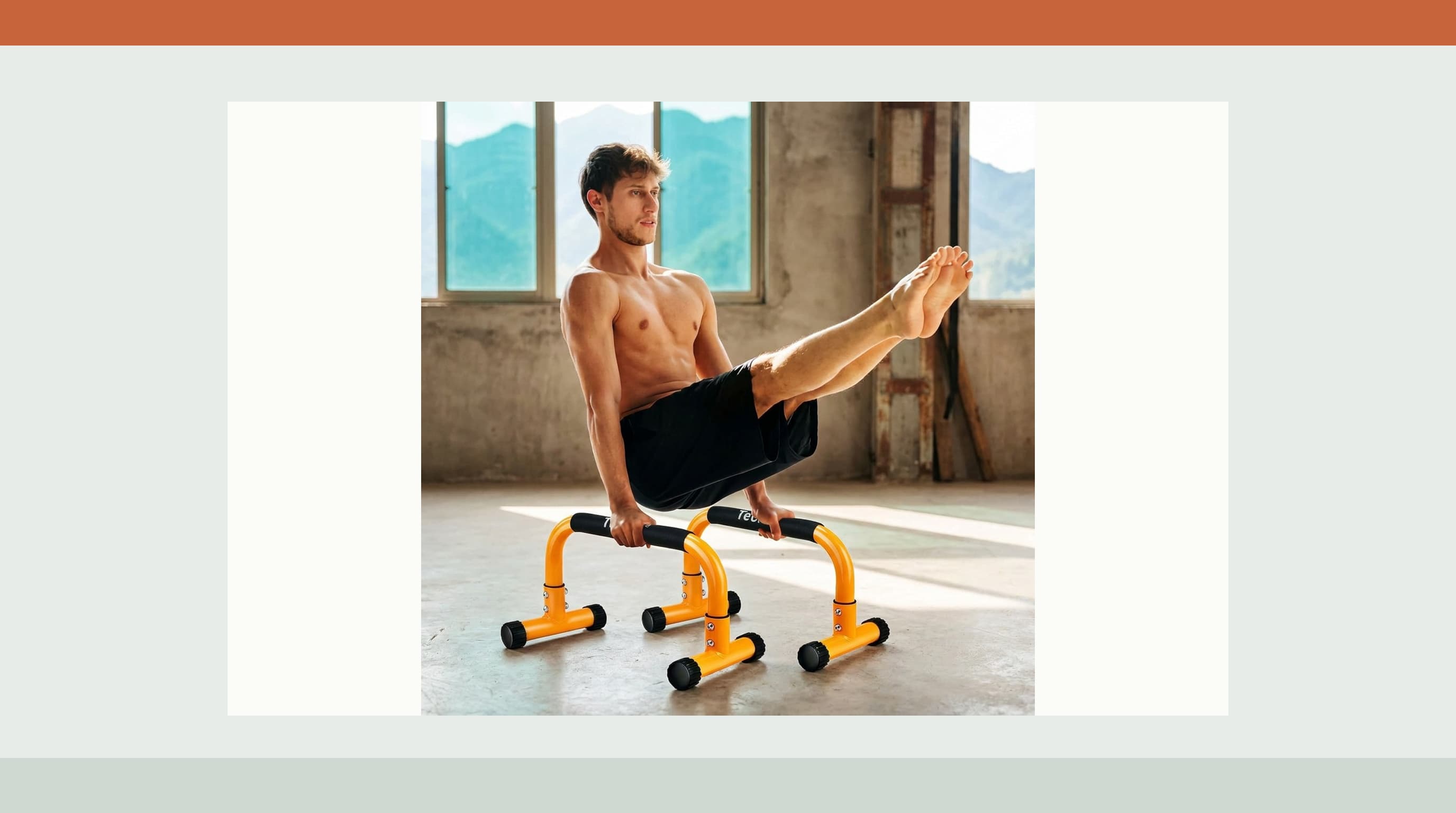 Orange Teclor 9.5 inch steel parallettes shown in use for an L-sit