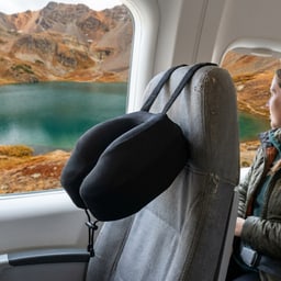 Cabeau Evolution S3 travel pillow secured to an airplane seat
