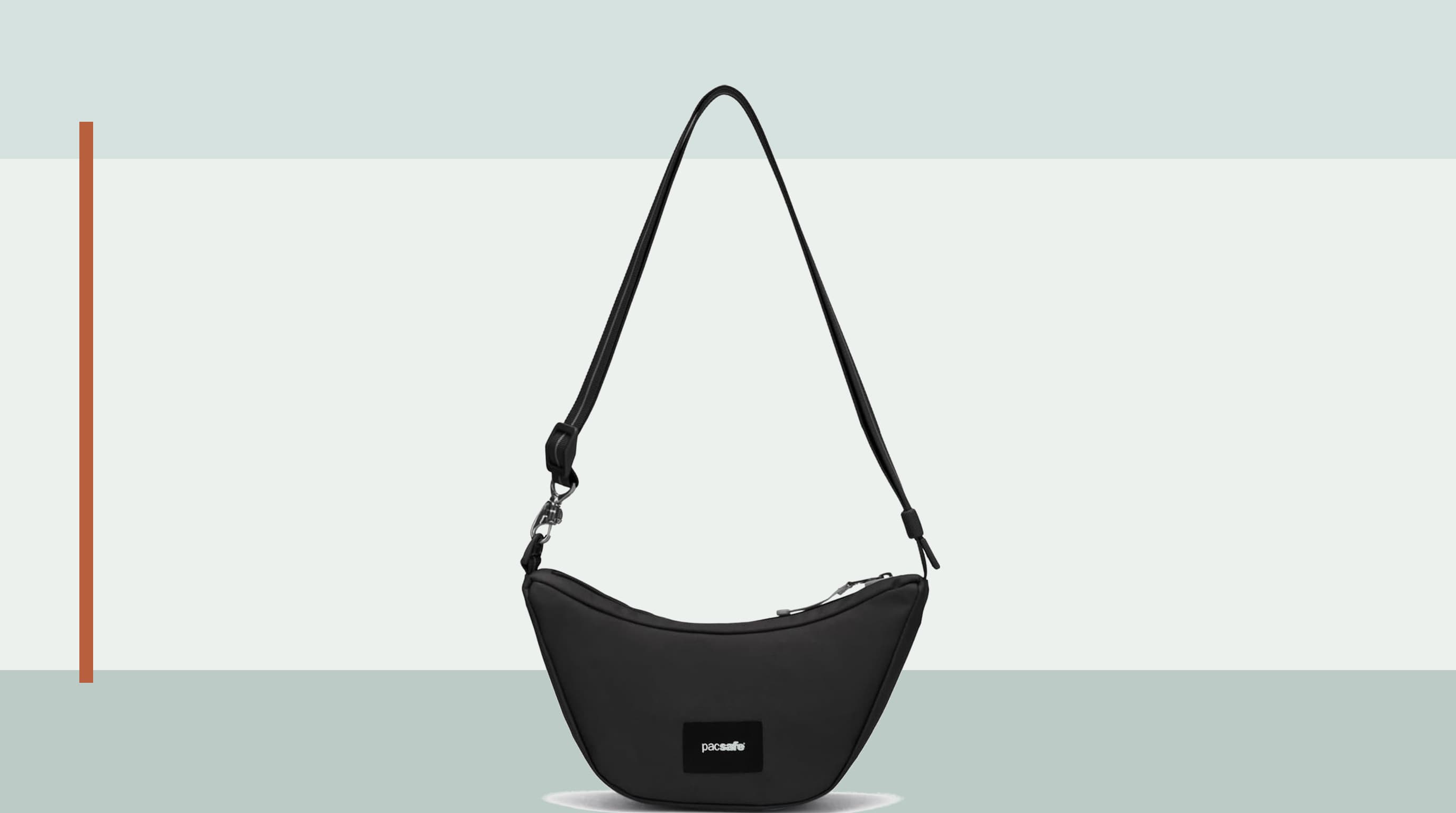 Pacsafe GO Lunar crescent crossbody shown in a compact city travel setup