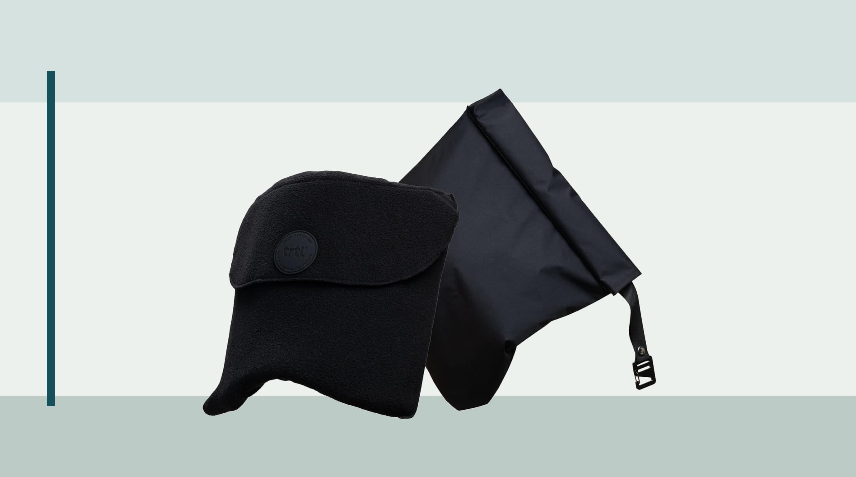 Trtl Travel Pillow Original wrapped around a traveler seated by an airplane window