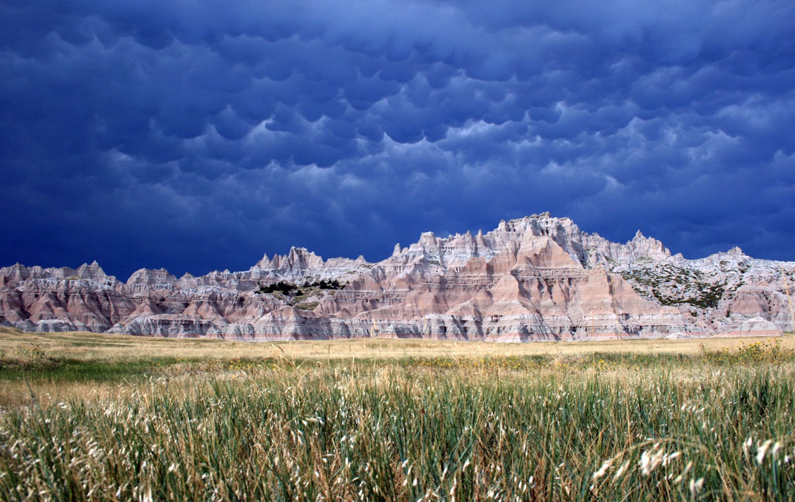 Layered Badlands formations below a building storm