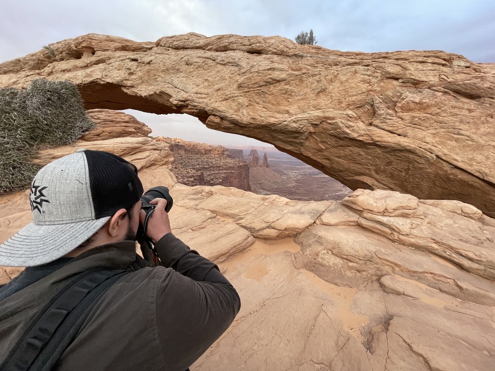 Mesa Arch framing the Canyonlands basin at twilight