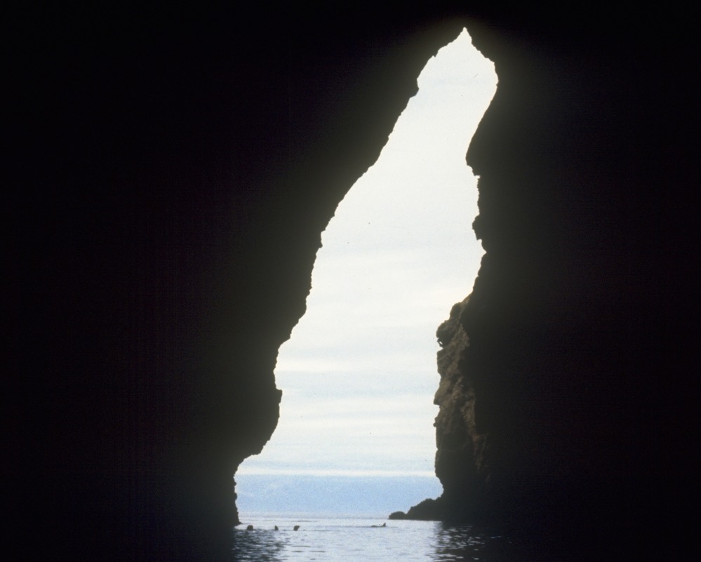 Sea cave walls and dark water inside Painted Cave on Santa Cruz Island