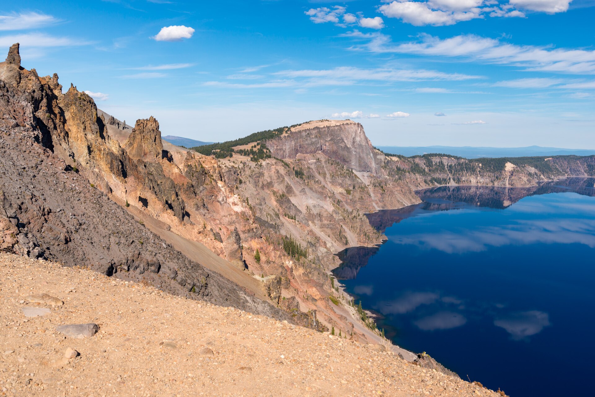 Rim Drive curving above the deep blue water of Crater Lake