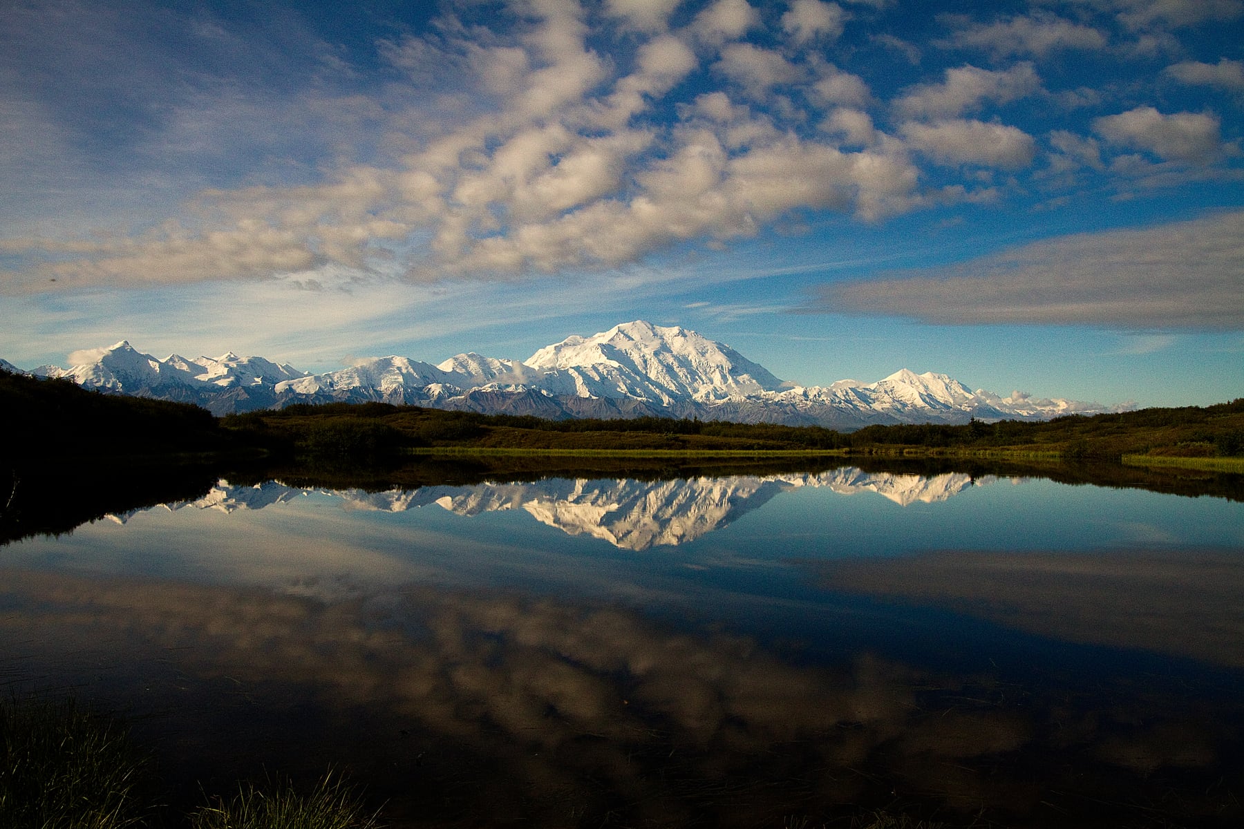 Snowy mountains reflected in a pond in Denali