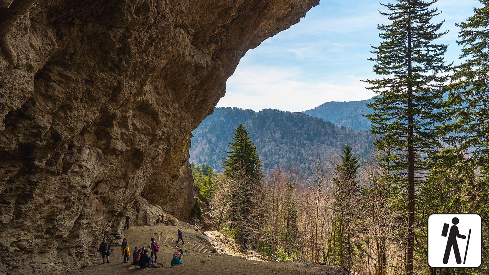 A rocky overhang and forested view along the Alum Cave Trail