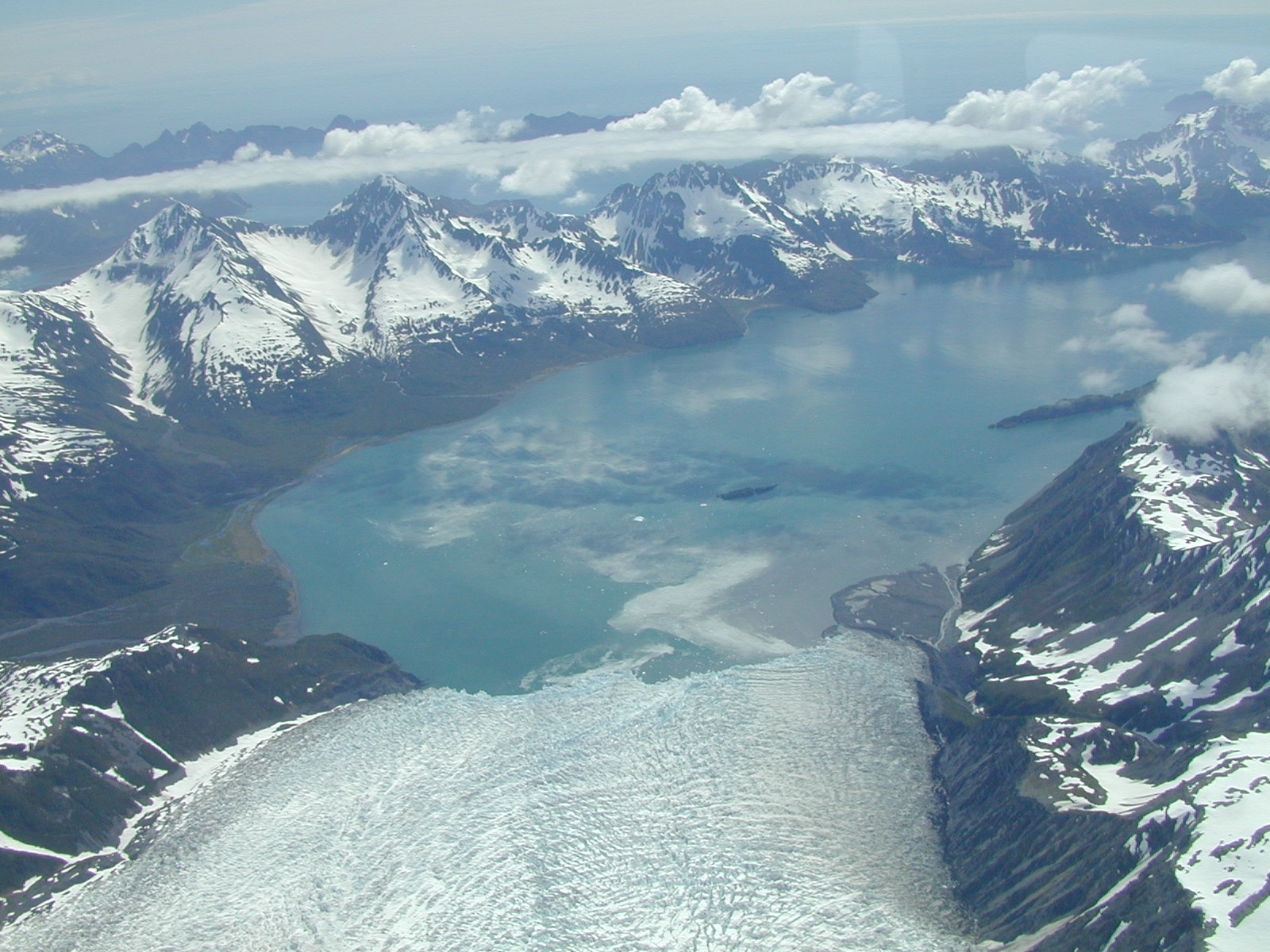 Aerial view of Aialik Glacier flowing toward the fjord