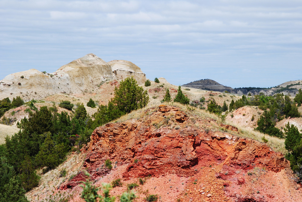 Red rock badlands and layered slopes in Theodore Roosevelt National Park